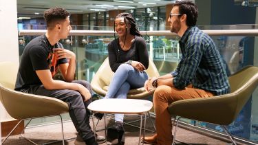 A group of students sit and chat in the Students' Union