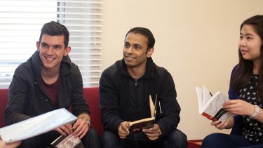 Postgraduate students participating in book discussion