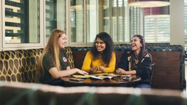 Students sat in a bar socialising 