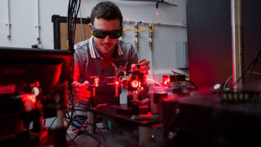 A Quantum Photonics student using lasers