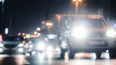 Car headlights on main road in the dark