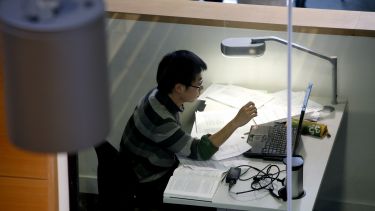 Student working on laptop in the library