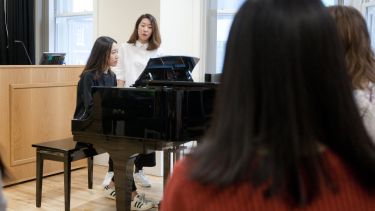A postgraduate student playing the piano