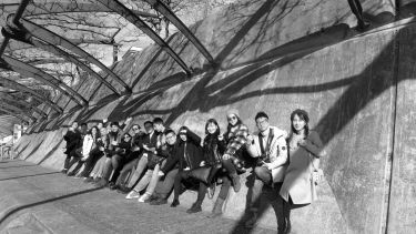 Digital architecture and design students sat on wall in Switzerland