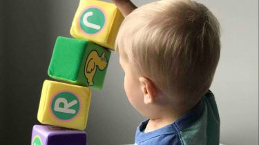 A child using spelling blocks. 