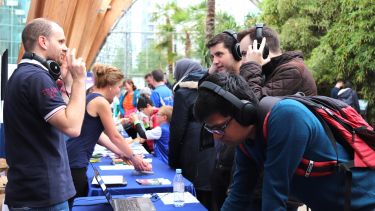 Hearing and Research group stall: people wearing headphones