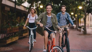 Students laughing on bikes 