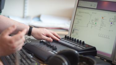 A student using a mixing desk and software