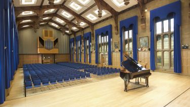 Firth Hall laid out with seating and a grand piano
