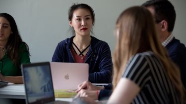 Students sat around desks with laptops