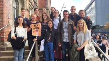 group of students with a pick Dutch poster