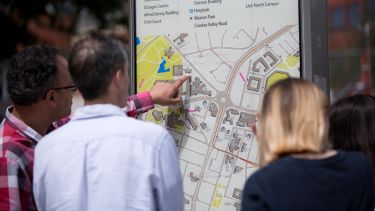 Visitors at an open day looking at a map