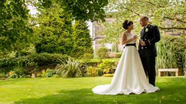 A couple getting married in the garden outside the Halifax Hall Hotel