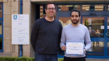 Prof. Phil McMinn and Ibrahim Althomali in front of Regent Court with their IEE paper award
