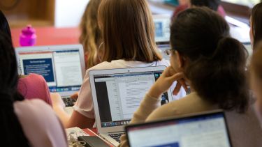 A group of students studying on laptops