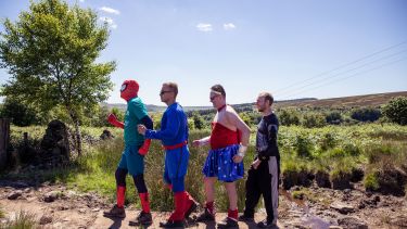 Community fundraisers undertaking The Big Walk dressed as superheros