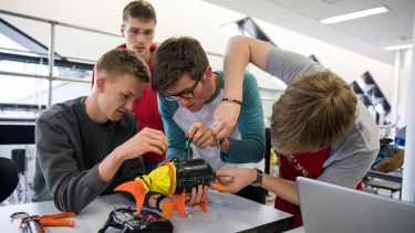 An image of a group of students working on a robot fish