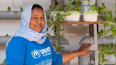 Syrian refugee with hydroponics-grown plants in the Zaatari refugee camp in Jordan