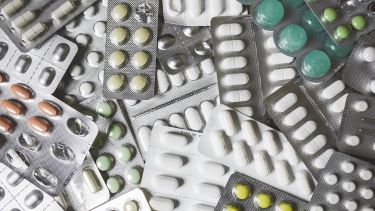 Lots of medication, pills and lozenges, in a pile - image 