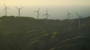 Looking down to a wind farm during a sunset in Wellington