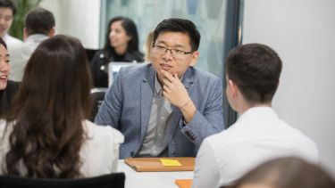 Three students chatting in class