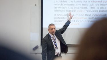 A lecturer delivering a presentation