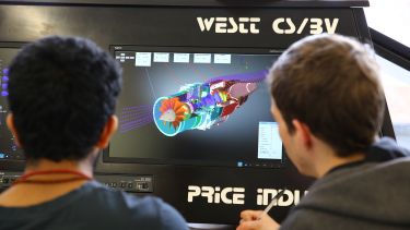 Aerospace Students studying a computer simulation of a turbine