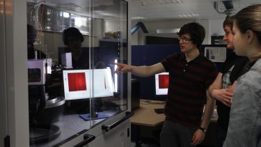 A scientist demonstrates X-ray crystallography equipment