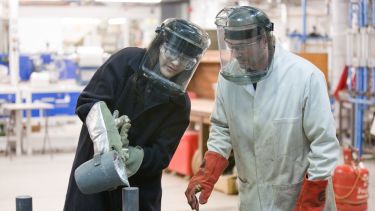 Engineering students wearing safety masks in a lab.