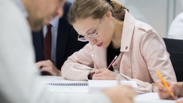 A student takes notes in class