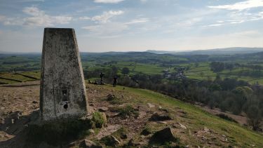 A trig point and view of the Peak District