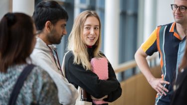 group of students chatting and smiling