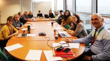 Photograph of Archaeology Strategic Board sat around a conference table 