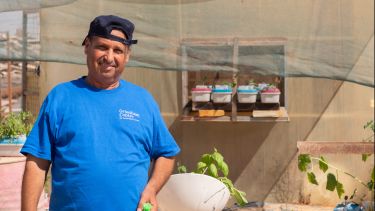 Picture of a man wearing a blue t-shirt in the Zaatari refugee camp in Jordan