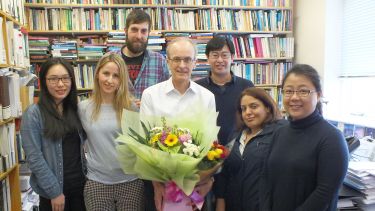 Professor Alan Walker with a group of his PhD students.