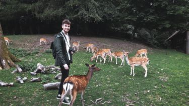 Joseph in a field of deer during his summer school
