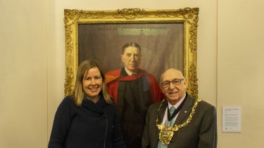 Dr Sally Hall and the Lord Mayor of Sheffield standing with a portrait of Sir Arthur