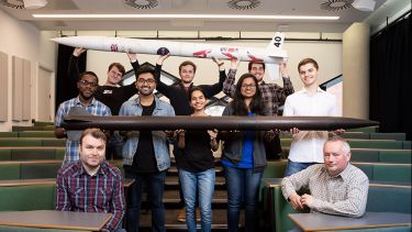 The Sunride team holding up their rockets