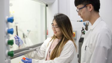 Two chemistry students in lab using equipment