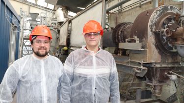 Visa Isteri (left) and Dr Theodore Hanein (right) standing next to the kiln outlet at IBU-tec Weimar.