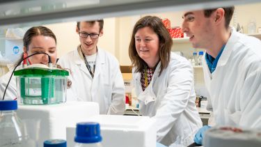 Dr Heather Mortiboys leading a team of Parkinson's researchers in a lab