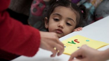 Photograph of girl observing an activitiy