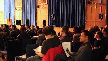 An audience sat ready to watch a USSS concert.