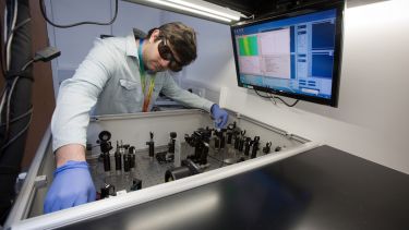 A researcher at the transient absorption station in the Ultrafast Laser Spectroscopy Laboratory