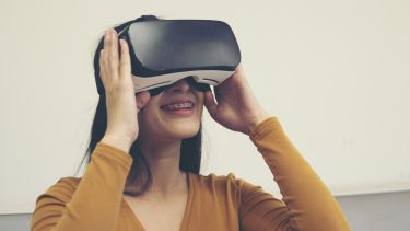 A woman uses a VR headset