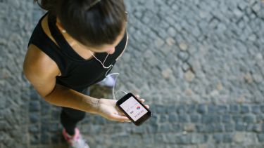 A runner checks a fitness tracking app