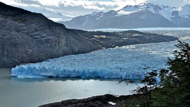 A photograph of glaciers with snowy mountains in the background.
