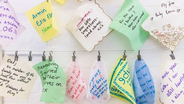 Little cards and handkerchiefs on a washing line with messages written on them for lost babies.