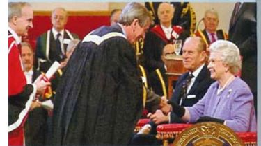 Alan Walker shaking hands with the Queen having received the Third Queen's Anniversary Prize