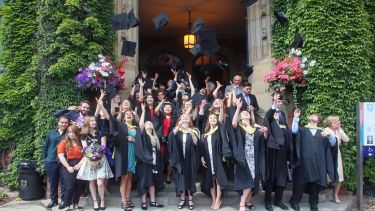 graduation - students celebrating by throwing thier caps in the air